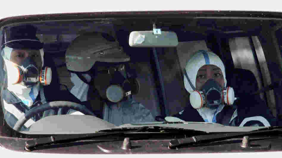 Police officers wore gas masks as they patrolled near the nuclear power plant in Fukushima prefecture today (March 12, 2011).