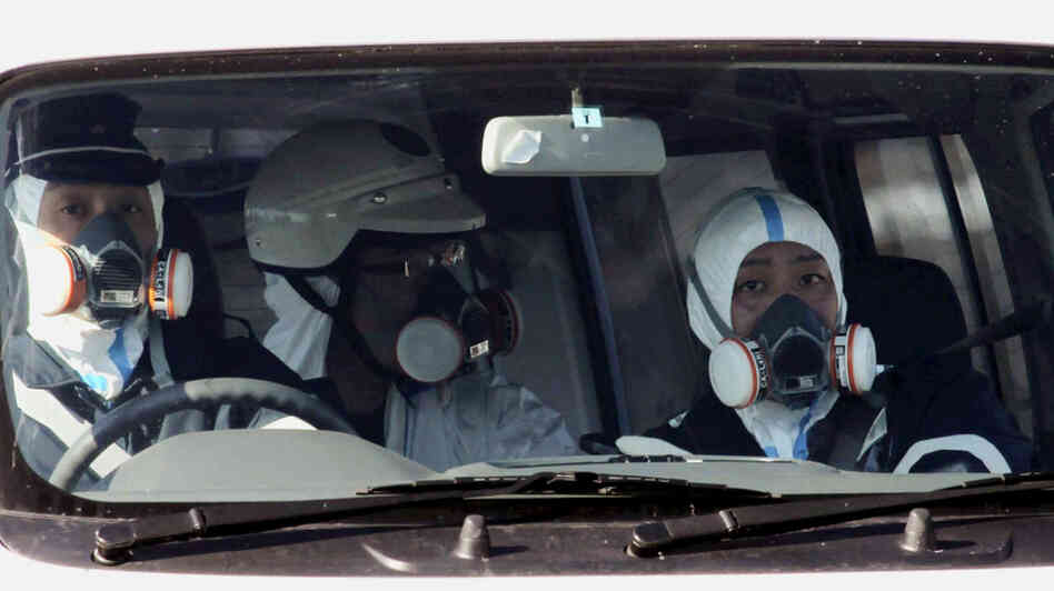 Police officers wore gas masks as they patrolled near the nuclear power plant in Fukushima prefecture today (March 12, 2011).