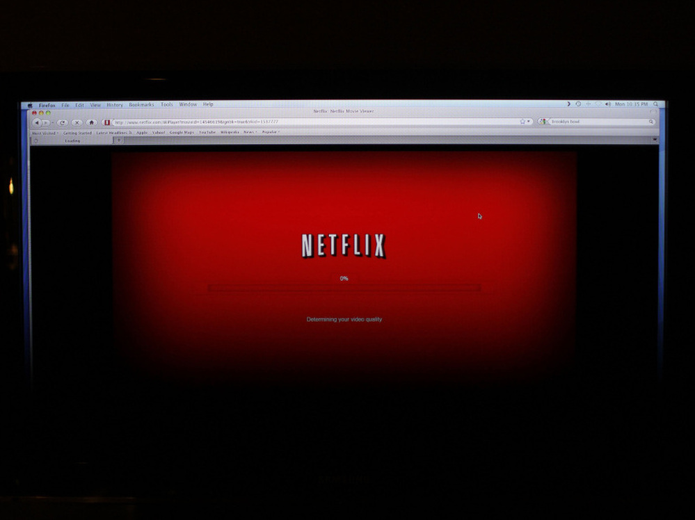 A movie selected from Netflix begins to download on a home computer screen. Other companies, including Amazon, are trying to woo more customers for online video services.