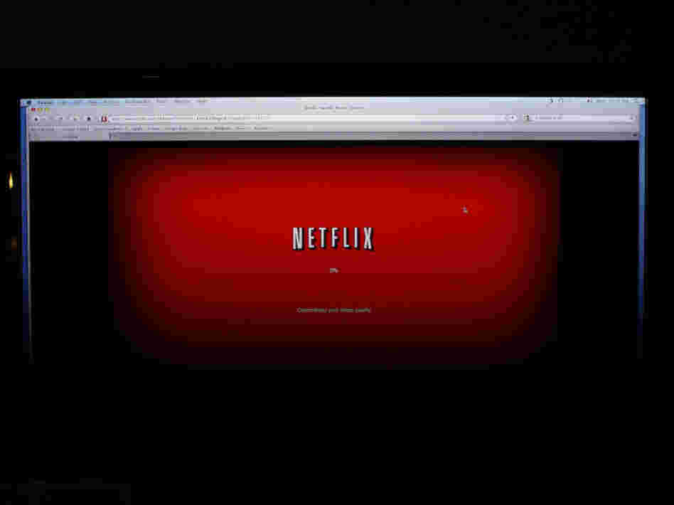 A movie selected from Netflix begins to download on a home computer screen. Other companies, including Amazon, are trying to woo more customers for online video services.