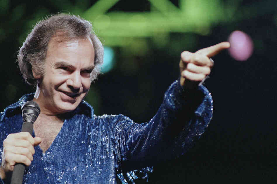 Diamond continued to churn out present-day classics like "Holly Holy" and "Song Sung Blue," which reached No.1 on the Hot 100. After performing in sold-out venues, Diamond released Hot August Night in 1972, an album critics hail as "the ultimate Neil Diamond record." Here, Diamond performs at New York's Madison Square Garden in 1986. 