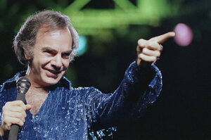 Diamond continued to churn out present-day classics like "Holly Holy" and "Song Sung Blue," which reached No.1 on the Hot 100. After performing in sold-out venues, Diamond released Hot August Night in 1972, an album critics hail as "the ultimate Neil Diamond record." Here, Diamond performs at New York's Madison Square Garden in 1986.