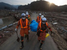 Japanese rescue team members carry the body of a man from the village of Saito, in northeastern Japan, Monday, March 14, 2011. Asia's richest nation faces a mounting humanitarian, nuclear and economic crisis in the aftermath of a massive earthquake and tsunami that likely killed thousands. Japanese rescue team members carry the body of a man from the village of Saito, in northeastern Japan, Monday, March 14, 2011. Asia's richest nation faces a mounting humanitarian, nuclear and economic crisis in the aftermath of a massive earthquake and tsunami that likely killed thousands.