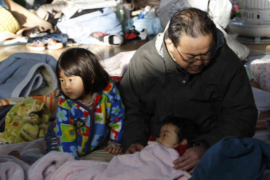 Families take shelter at a gym in Sendai, Japan. 