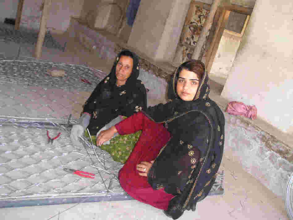 Kamila Sidiqi (foreground) teaches gabion-making while working with Mercy Corps. Sidiqi started her own business making clothes in Kabul while Afghanistan was under repressive Taliban rule, eventually employing over 100 women in her neighborhood. Kamila Sidiqi (foreground) teaches gabion-making while working with Mercy Corps. Sidiqi started her own business making clothes in Kabul while Afghanistan was under repressive Taliban rule, eventually employing over 100 women in her neighborhood.