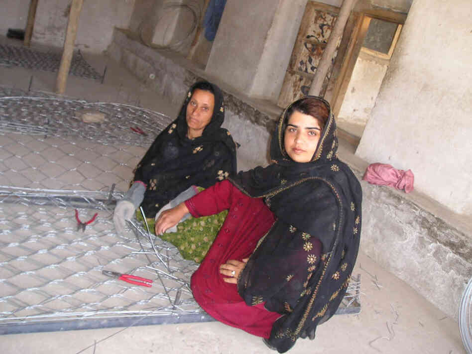 Kamila Sidiqi (foreground) teaches gabion-making while working with Mercy Corps. Sidiqi started her own business making clothes in Kabul while Afghanistan was under repressive Taliban rule, eventually employing over 100 women in her neighborhood. Kamila Sidiqi (foreground) teaches gabion-making while working with Mercy Corps. Sidiqi started her own business making clothes in Kabul while Afghanistan was under repressive Taliban rule, eventually employing over 100 women in her neighborhood.