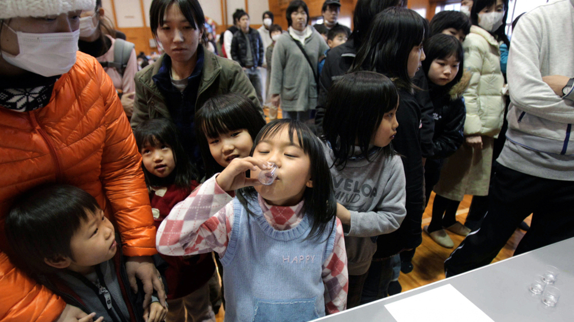Children in Kawamata, Japan, take potassium iodide on Monday to protect against thyroid cancer after being evacuated from the vicinity of the Fukushima Daiichi Nuclear Power Plant.
