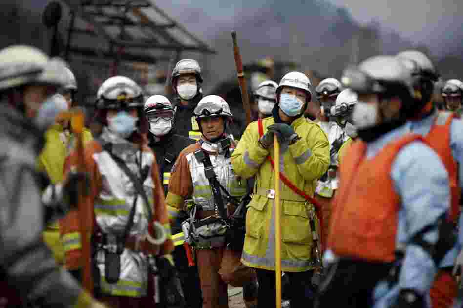 Civil defense teams search for survivors in Otsuchi, Japan on Tuesday. 