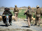 Three Afghan men on a motorcycle passed by as U.S. Marines patrolled last month in Afghanistan's Helmand Province. Three Afghan men on a motorcycle passed by as U.S. Marines patrolled last month in Afghanistan's Helmand Province.