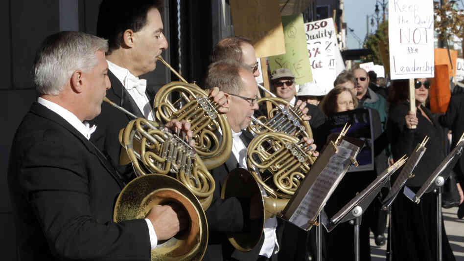 Members of the Detroit Symphony Orchestra play French horns while serenading their picketing colleagues outside the Max M. Fisher Music Center in Detroit, on Oct. 4, 2010. The musicians  called a strike after refusing to accept pay cuts of more than 30 percent demanded by the financially struggling Detroit Symphony Orchestra.
