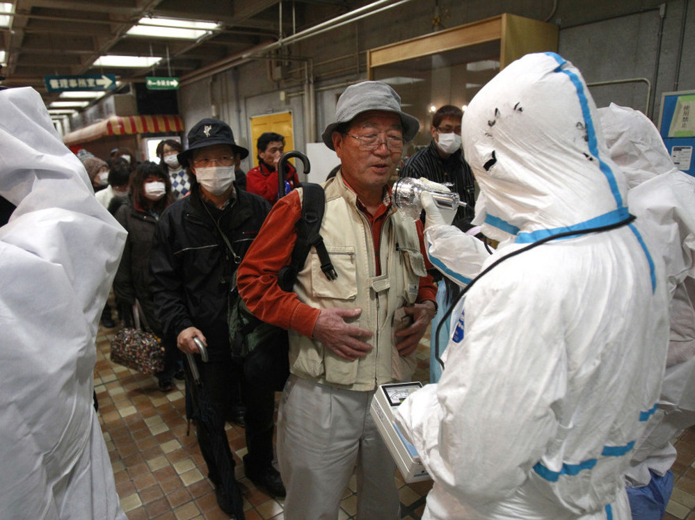 An evacuee is screened for radiation exposure at a testing center on Tuesday in Koriyama, Japan, after a nuclear power plant on the coast of the Fukushima prefecture was damaged by Friday's earthquake.