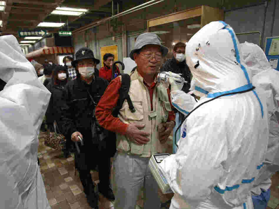 An evacuee is screened for radiation exposure at a testing center on Tuesday in Koriyama, Japan, after a nuclear power plant on the coast of the Fukushima prefecture was damaged by Friday's earthquake.
