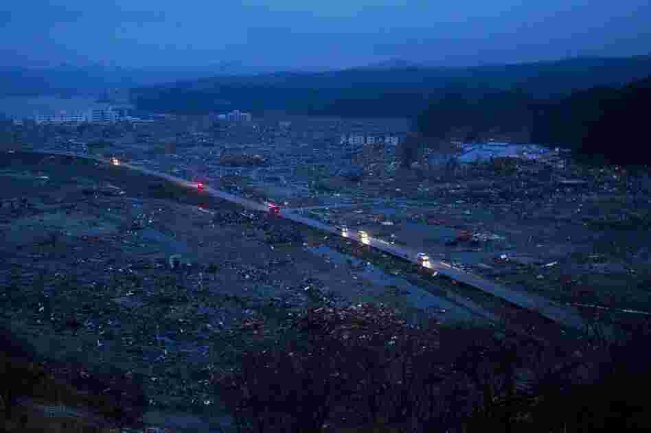 Cars drive through the ruins of the leveled city of Minamisanriku, northeastern Japan on Tuesday. 
