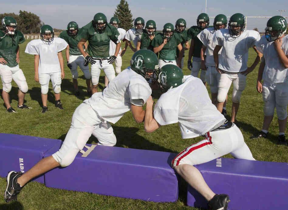 Players for the combined football team of Sandhills High School and Thedford High School train during practice in Dunning, Neb., in 2009.