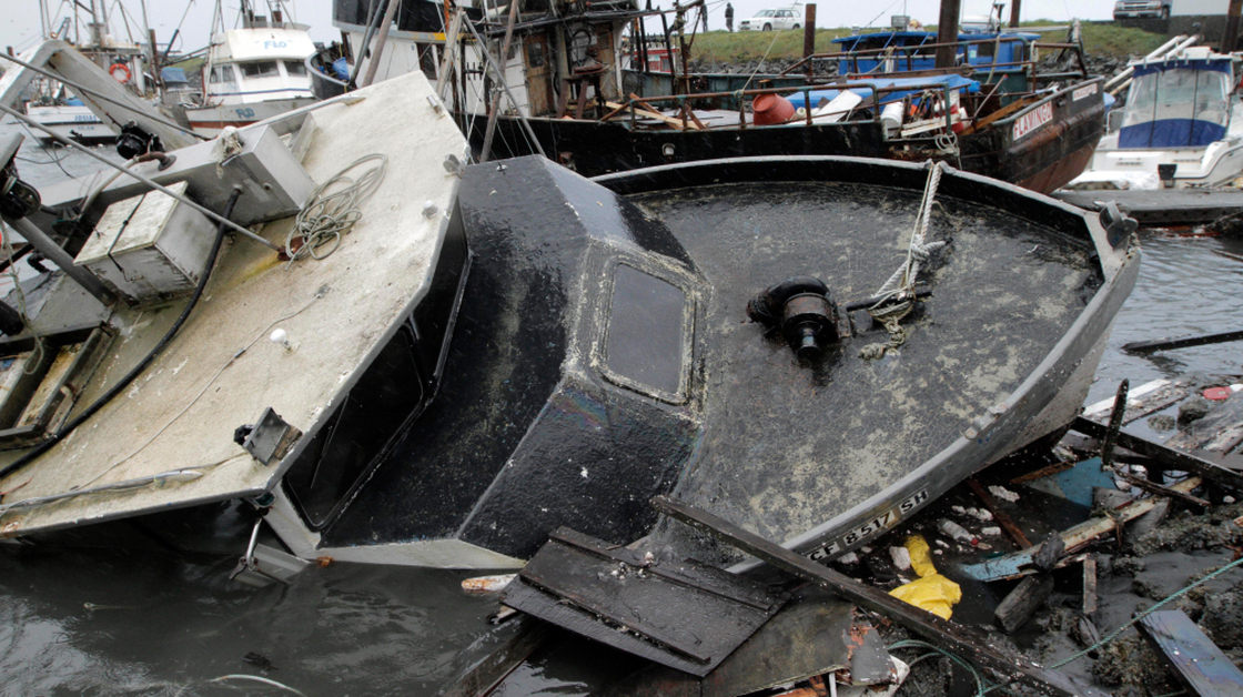 Half-sunken boats, docks and debris lie tangled in Crescent City, Calif., after a tsunami surged Friday in Northern California.