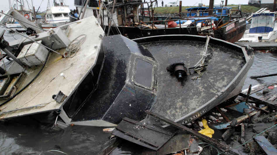 Half-sunken boats, docks and debris lie tangled in Crescent City, Calif., after a tsunami surged Friday in Northern California.