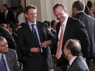 Treasury Secretary Timothy Geithner, standing left, shares a laugh with David Axelrod, seated right, October 2010. Treasury Secretary Timothy Geithner, standing left, shares a laugh with David Axelrod, seated right, October 2010.