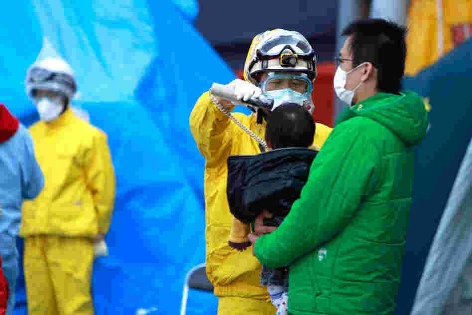 A child is checked for radiation exposure. More than 200,000 people in the area surrounding the reactors have been evacuated. 