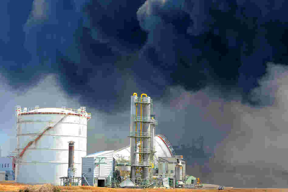 Smoke billows from fires raging at the port in Tagajo, Miyagi prefecture. 