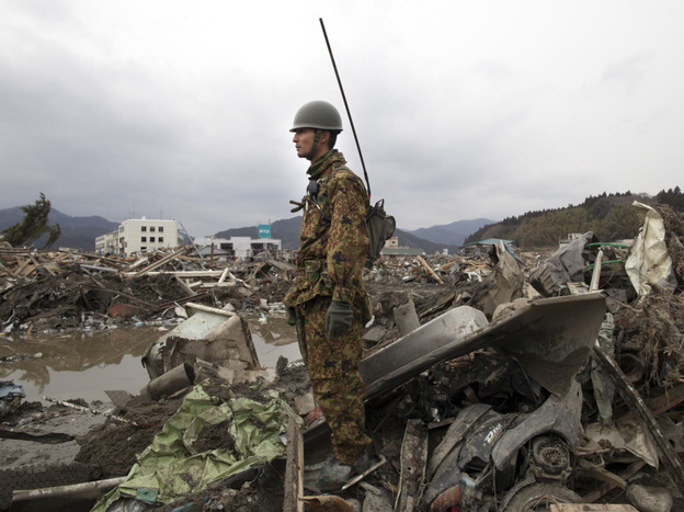 A Japanese soldier stood watch earlier today (March 15, 2011) over the rubble of what was Rikuzen-Takada City in Japan.
