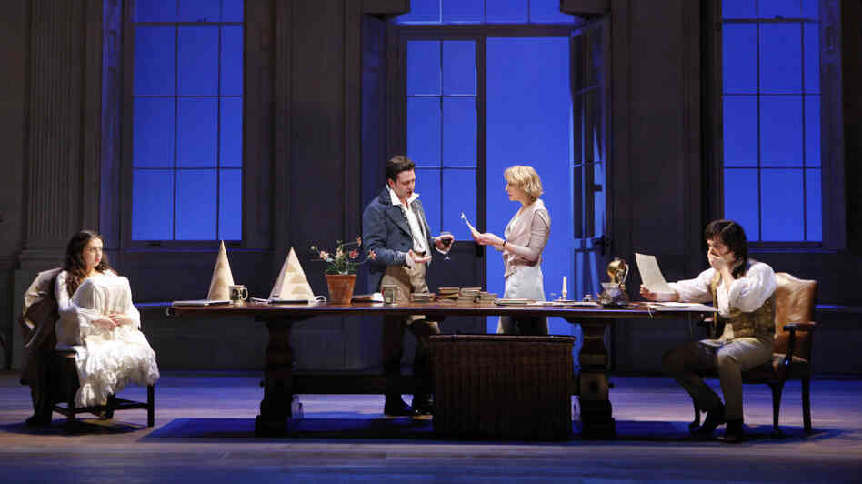 Two Houses, Both Alike: In a scene that fuses two moments across two centuries, 19th-century math prodigy Thomasina (Bel Powley, left) and her tutor Septimus (Tom Riley) flank the central table of Arcadia's set, joined in the center by the present-day Valentine (Raul Esparza) and Hannah (Lia Williams). Two Houses, Both Alike: In a scene that fuses two moments across two centuries, 19th-century math prodigy Thomasina (Bel Powley, left) and her tutor Septimus (Tom Riley) flank the central table of Arcadia's set, joined in the center by the present-day Valentine (Raul Esparza) and Hannah (Lia Williams).