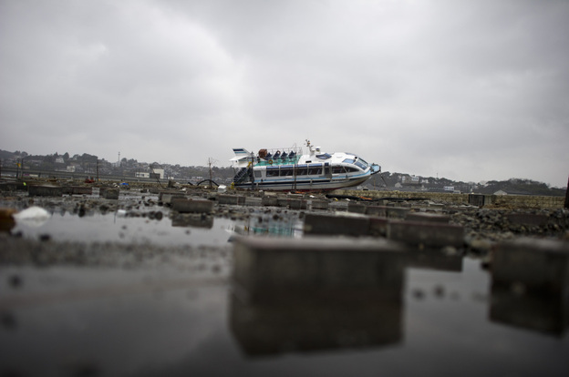 In Japan, the first recorded use of the word "tsunami" occurred well over 1,000 years ago. Tuesday, a boat lay aground after being washed inshore near Sendai.
