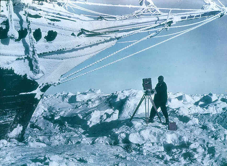 Frank Hurley photographs the frozen bow of the Endurance. Frank Hurley photographs the frozen bow of the Endurance.