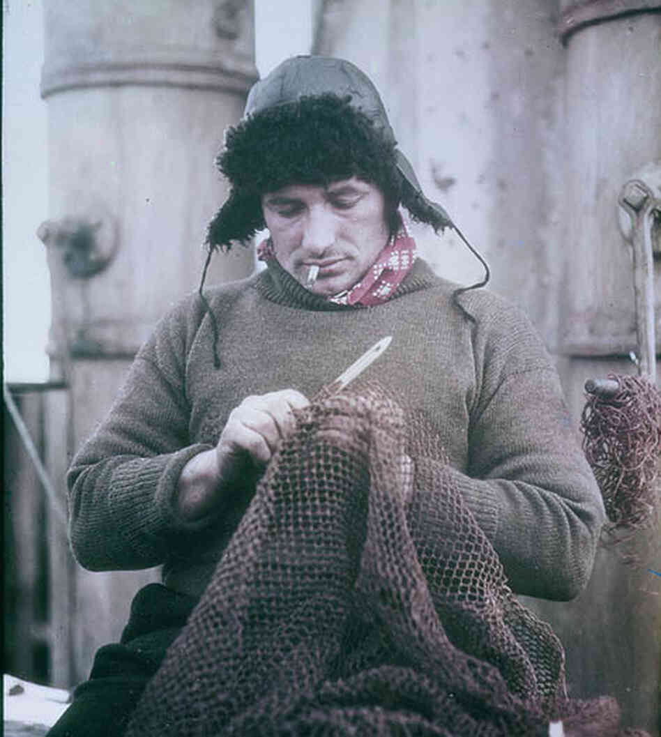 John Vincent mends a net.
