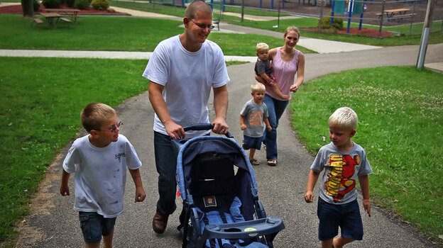 Sgt. Nathan Scheller was twice denied for a Purple Heart, though  roadside bomb explosions left him with lasting cognitive damage. Above, Scheller walks with his wife, Miriam, and his family.