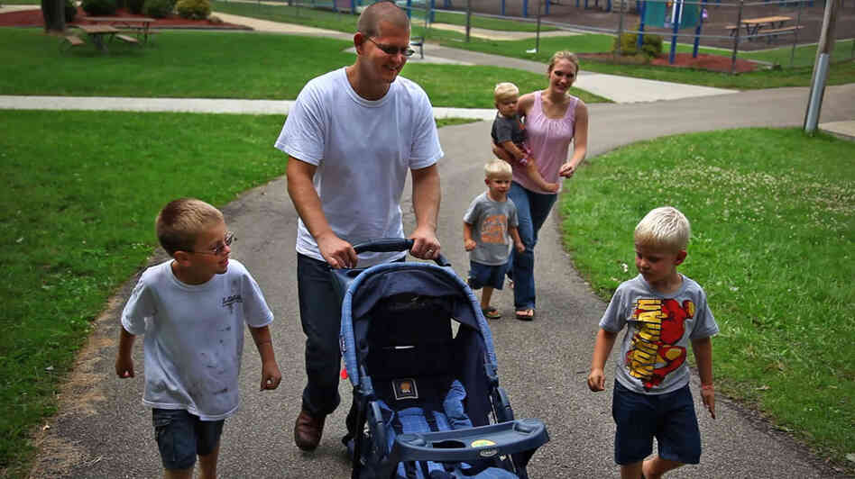Sgt. Nathan Scheller was twice denied for a Purple Heart, though  roadside bomb explosions left him with lasting cognitive damage. Above, Scheller walks with his wife, Miriam, and his family.