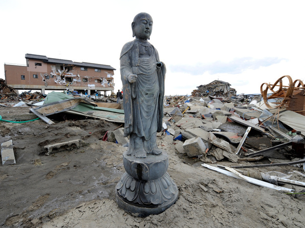 A religious statue stands amid the debris left by last Friday's tsunami in Natori, Miyagi prefecture. Many Japanese will turn to Shinto and Buddhist rituals as they cope with the disaster stemming from a powerful earthquake.