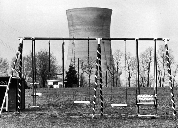 A cooling tower of the Three Mile Island nuclear power plant near Harrisburg, Pa., looms behind an abandoned playground on March 30, 1979, two days after the initial reactor emergency.