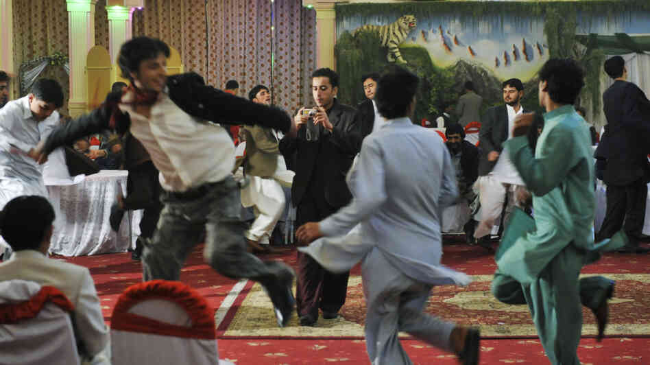 Afghan men dance at a wedding party in Kabul in October 2009. Celebrating weddings with dance and music returned to Afghanistan after the practice was banned during the Taliban regime. In a country where most Afghans are poor, this 600-guest reception cost about $5,000. Afghan men dance at a wedding party in Kabul in October 2009. Celebrating weddings with dance and music returned to Afghanistan after the practice was banned during the Taliban regime. In a country where most Afghans are poor, this 600-guest reception cost about $5,000.