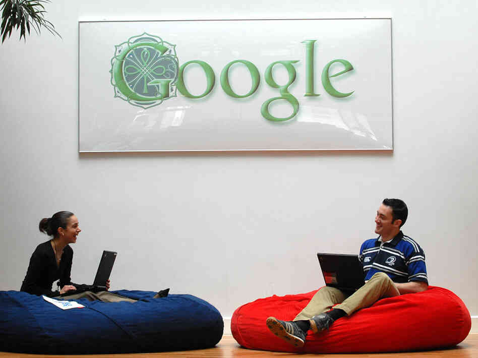 Employees at Google's Dublin office relax underneath the Irish-themed Google logo. Shifting most of its overseas profits through the Dublin office has saved Google billions in taxes.