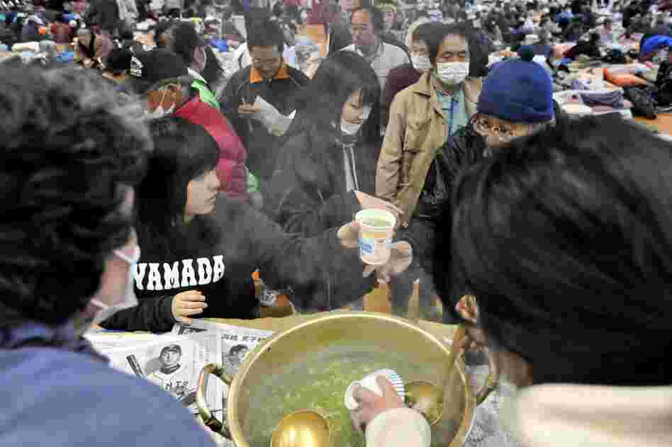 Evacuees receive bowls of soup at a makeshift shelter in Yamada, northern Japan. Basic supplies remain scarce in regions heavily damaged by the earthquake and tsunami. 