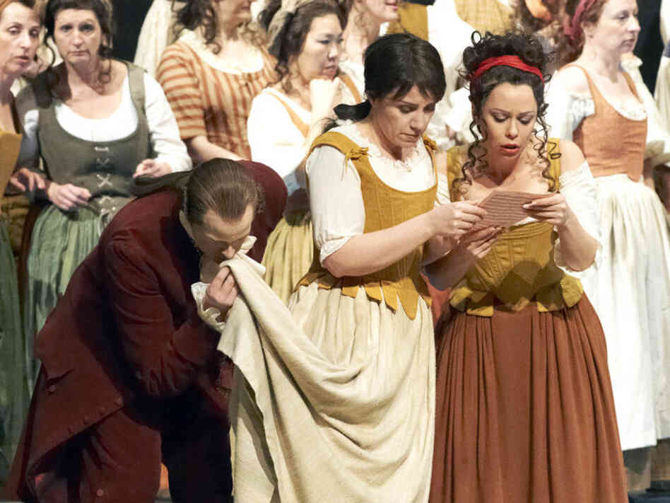 Cherubino (Anna Bonitatibus, center), dressed as Susanna, prepares to deceive the Count.
