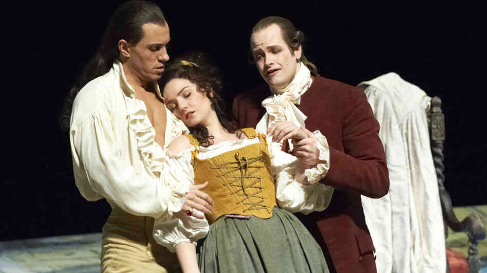 The scheming Count Almaviva (Erwin Schrott, left) and Basilio the music master (Benjamin Bruns) prop up a swooning Susanna (Slyvia Schwartz), the object of the Count's nefarious affections.