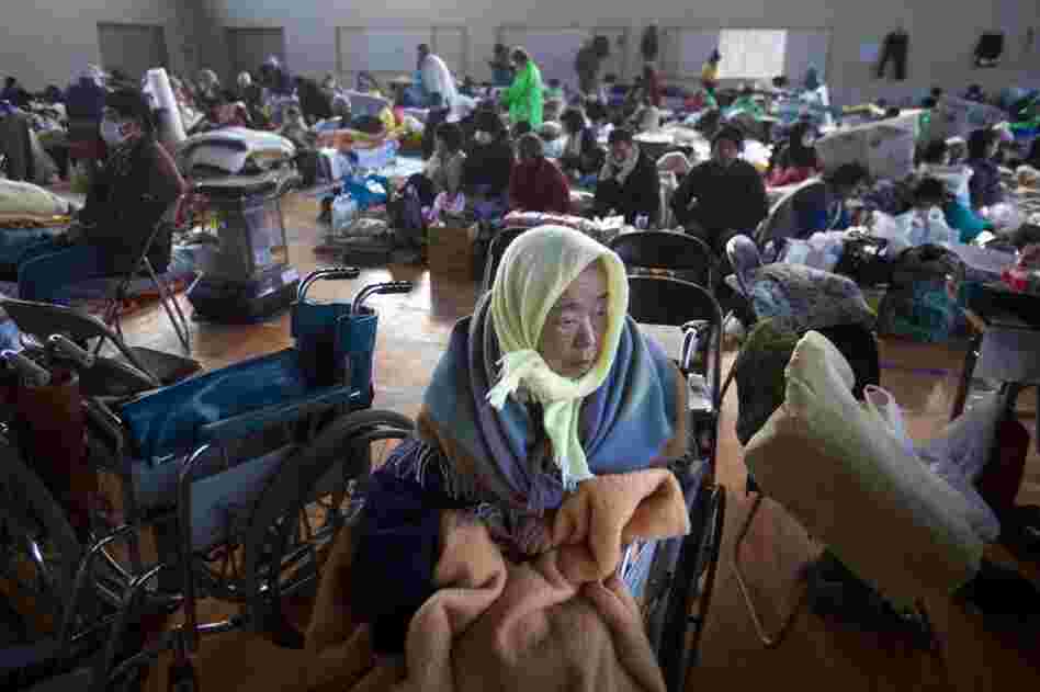 Refugees, including 53 who were saved from a retirement home, take shelter inside a school gym in the leveled city of Kesennuma, northeastern Japan. 