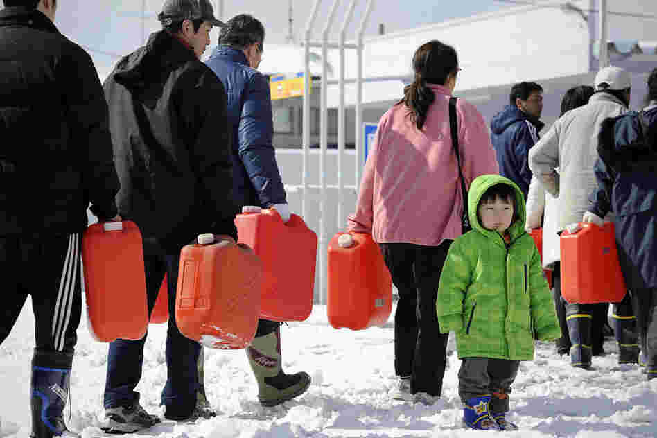 People wait in line for gasoline at a filling station in Ichinoseki, Iwate.  Heavy blizzards swept across Japan's northeast overnight. 