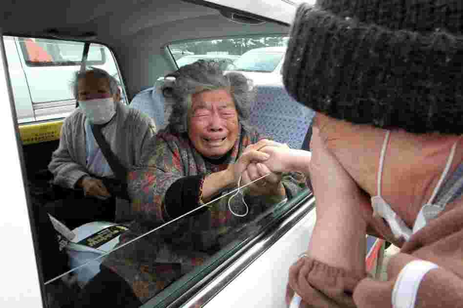 Fuyo Murakami (center) and her husband Yoshiro (left) say goodby to a relative as they leave for Hokkaido in northern Japan. 