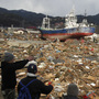Survivors overlook the earthquake and tsunami-hit area in Kesennuma, Miyagi prefecture, Japan, on Thursday. Survivors overlook the earthquake and tsunami-hit area in Kesennuma, Miyagi prefecture, Japan, on Thursday.