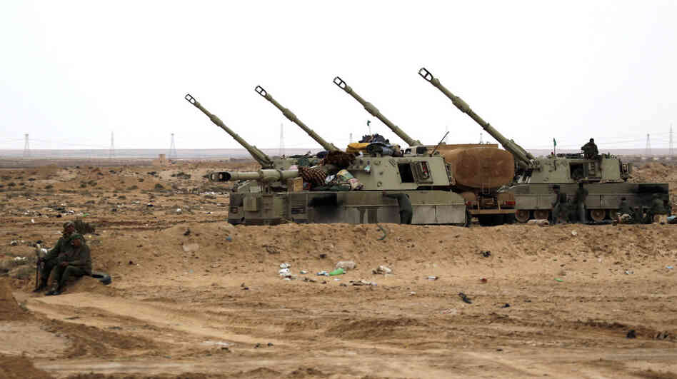 Libyan soldiers loyal to Moammar Gadhafi man artillery cannons at the western entrance of the city of Ajdabiya on Wednesday.