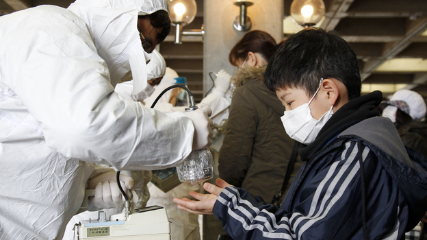A boy evacuated from Koriyama, some 37 miles from the Fukushima Dai-ichi plant, gets scanned with a Geiger counter Wednesday.