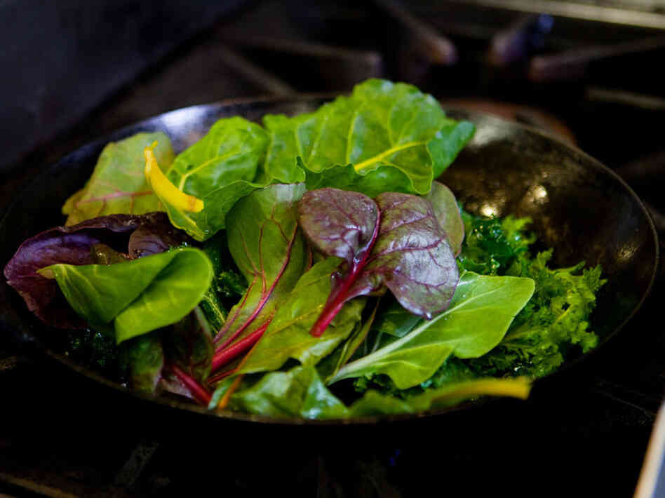 Mixed baby greens perched in their pan, waiting for a quick saute. Mixed baby greens perched in their pan, waiting for a quick saute.