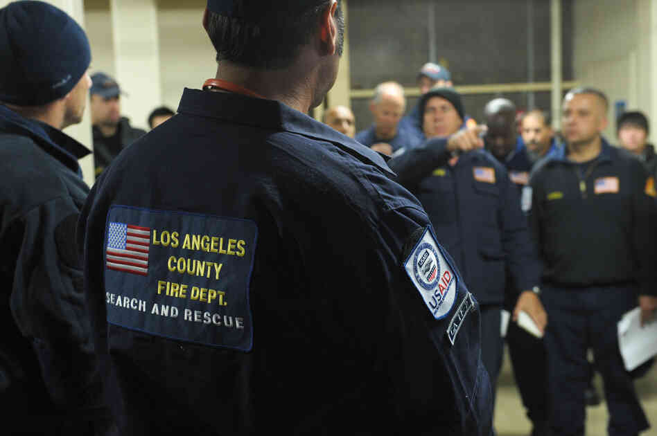 Members of search and rescue teams from Los Angeles County and Fairfax County, Va., get a briefing Monday before heading to Japan to help with rescue and recovery efforts. Members of search and rescue teams from Los Angeles County and Fairfax County, Va., get a briefing Monday before heading to Japan to help with rescue and recovery efforts.