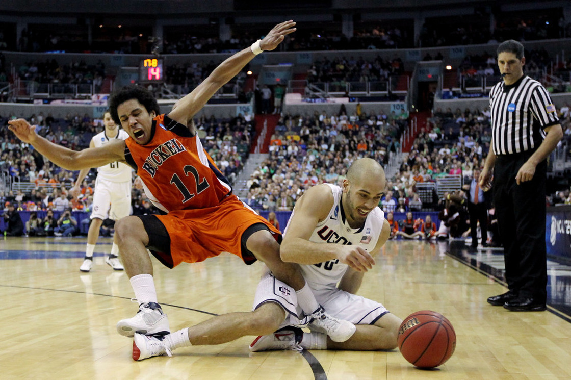 Benjamin Stewart #23 of the Connecticut Huskies fights for a loose ball with Bryson Johnson #12 of the Bucknell Bison on March 17, 2011 in Washington, DC.