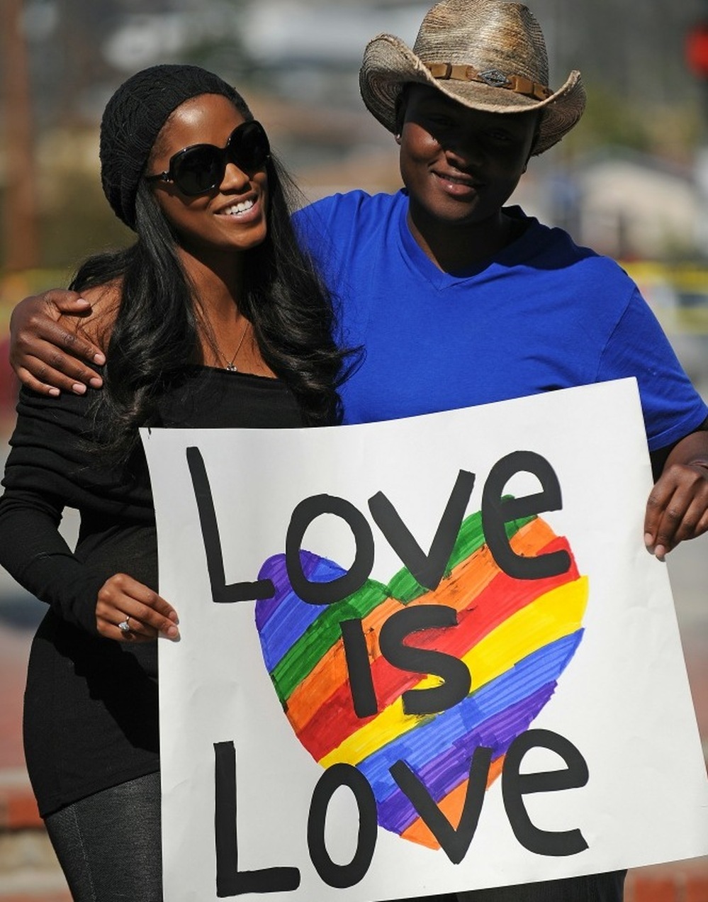 A lesbian couple hold a sign at a protest calling for the right for gays and lesbians to marry outside the County Clerk s Office in Los Angeles on Valentine's Day, 2011.
