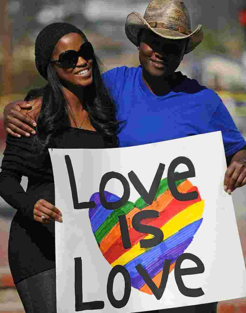 A lesbian couple hold a sign at a protest calling for the right for gays and lesbians to marry outside the County Clerk s Office in Los Angeles on Valentine's Day, 2011.
