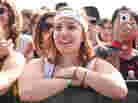 Claudia Garate of Austin, Texas, watches Man Man play at Auditorium Shores Saturday at SXSW.