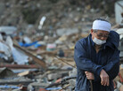 Surrounded by debris in the devastated city of Rikuzen-Takada, Japan, a man rested on his walking stick earlier today (March 19, 2011). Surrounded by debris in the devastated city of Rikuzen-Takada, Japan, a man rested on his walking stick earlier today (March 19, 2011).